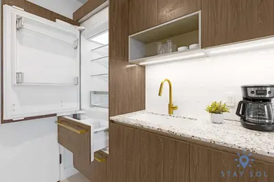 a kitchen with a sink and a coffee maker on a counter at Chic Downtown - City Views Gym & Pool in Miami