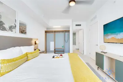 a bedroom with a large bed and a yellow rug at Oasis Apartment 1 Bedroom with Pool & Gym in Miami