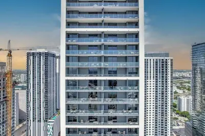 a tall white building in a city with tall buildings at Oasis Apartment 1 Bedroom with Pool & Gym in Miami