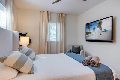 a bedroom with a large white bed and a window at Luxury Home in Brickell Miami, 5 min to the Beach! in Miami