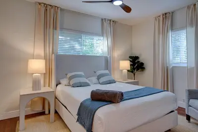 a bedroom with a large white bed with blue pillows at Luxury Home in Brickell Miami, 5 min to the Beach! in Miami