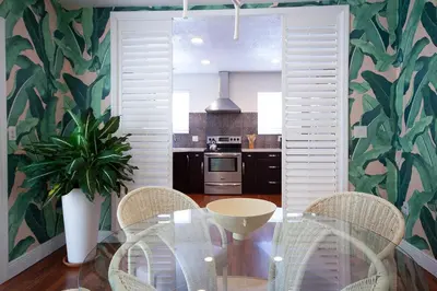 a dining room with a glass table and chairs at Luxury Home in Brickell Miami, 5 min to the Beach! in Miami