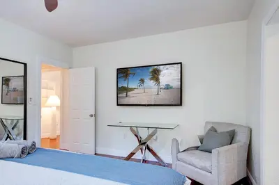a bedroom with a bed and a desk and a chair at Luxury Home in Brickell Miami, 5 min to the Beach! in Miami