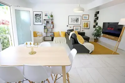 a living room with a table and chairs at 3 Minute Walk to Miami Beach Family and Pet Friendly Apartment in Miami Beach
