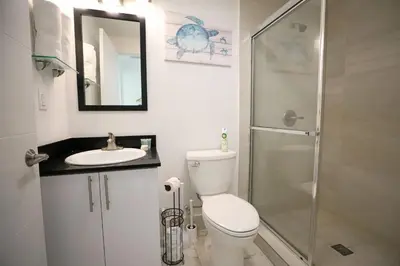 a bathroom with a toilet and a sink and a shower at 3 Minute Walk to Miami Beach Family and Pet Friendly Apartment in Miami Beach
