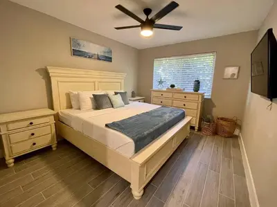 a bedroom with a bed and a ceiling fan at 2Bdrm 1Bath Newly Renovated Condo - Walk to the Beach! in Fort Lauderdale
