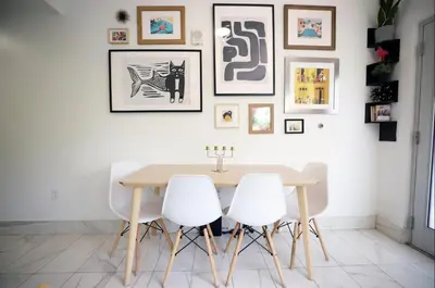 a dining room with a wooden table and white chairs at Family Friendly Condo Steps to Miami Beach with Free Parking in Miami Beach