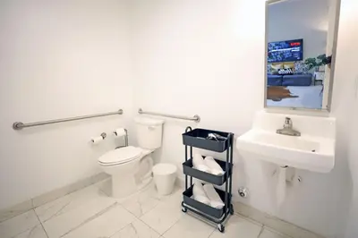 a bathroom with a toilet and a sink and a mirror at 3 Bedroom 3 Bathroom Miami Beach Apartment in Miami Beach