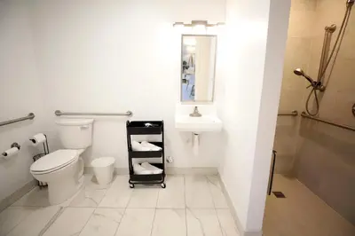 a white bathroom with a toilet and a sink at 3 Bedroom 3 Bathroom Miami Beach Apartment in Miami Beach