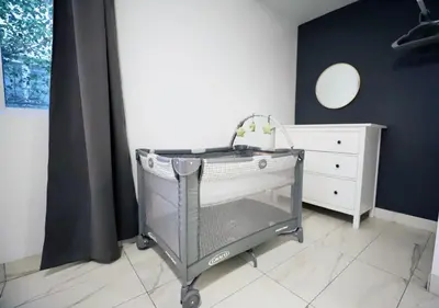 a shopping cart in a room with a dresser at 3 Bedroom 3 Bathroom Miami Beach Apartment in Miami Beach