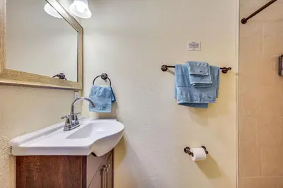 a bathroom with a sink and a mirror at 11 Mi to South Beach Home with Screened Porch! in Miami