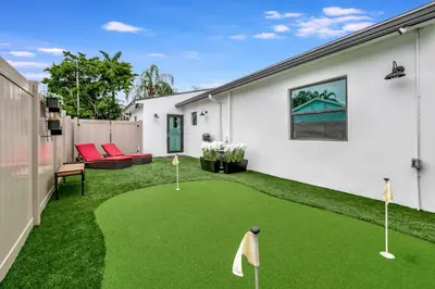 a yard with a putting green with miniature golf balls at Contemporary 3BR 3 BA Duplex, Amazing Outdoor Area in Fort Lauderdale