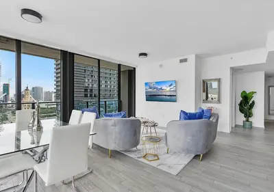 a living room with couches and a table and chairs at X Lounge II-Highline Corner Residence in Miami