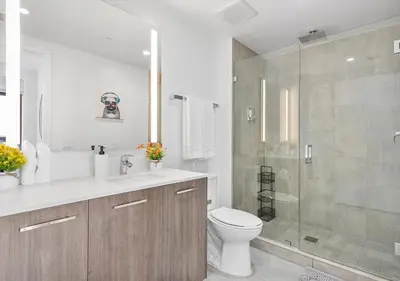 a bathroom with a toilet and a glass shower at X Lounge II-Highline Corner Residence in Miami