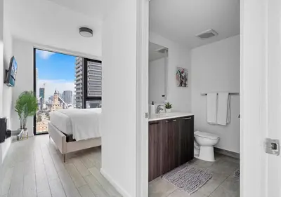 a bedroom with a bed and a sink and a toilet at X Lounge II-Highline Corner Residence in Miami
