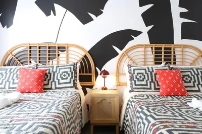 two beds sitting next to each other in a bedroom at Ocean Drive South Beach Miami in Miami Beach