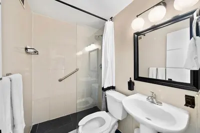 a bathroom with a toilet and a sink and a shower at Ocean Drive South Beach Miami in Miami Beach