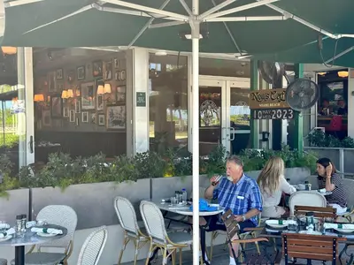a group of people sitting at tables in a restaurant at Ocean Drive Steps to Sea in South Beach with Free Parking in Miami Beach