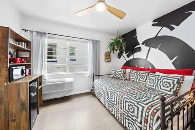 a bedroom with a bed and a window at Ocean Drive Oasis in Art Deco District of South Beach in Miami Beach