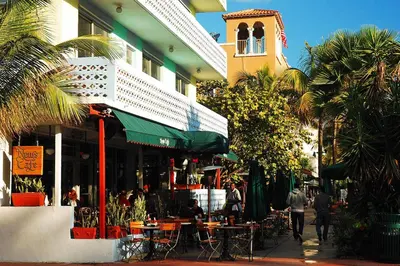 a street with tables and chairs and a building at Ocean Drive Oasis in Art Deco District of South Beach in Miami Beach