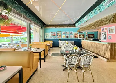 a dining room with tables and chairs in a restaurant at Ocean Drive Oasis in Art Deco District of South Beach in Miami Beach