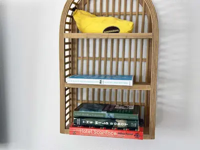 a book shelf with books and a yellow bag on it at Beachfront Ocean Drive South Beach Miami in Miami Beach