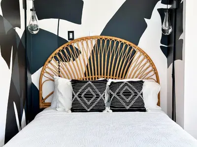 a bedroom with a bed with black and white pillows at Ocean Drive Oasis Beach Views South Beach Miami in Miami Beach