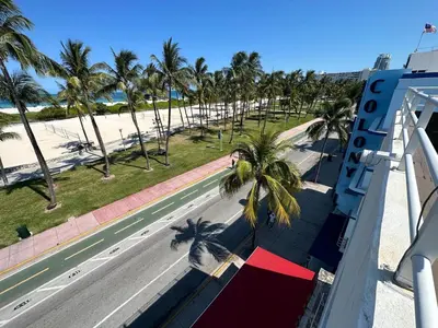 a view from the balcony of a resort with palm trees at Ocean Drive Oasis Beach Views South Beach Miami in Miami Beach