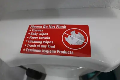 a sign on the top of a toilet bowl at Spacious Private Room Close to Miami Attractions in Miami