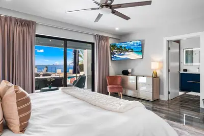 a bedroom with a bed and a view of the ocean at Best Bayfront View Villa with Heated Pool in North Bay Village