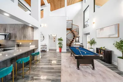 a pool table in a room with a bar at Best Bayfront View Villa with Heated Pool in North Bay Village