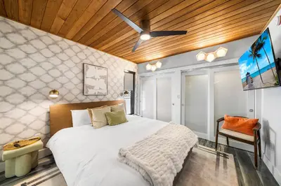a bedroom with a large bed and a ceiling fan at Best Bayfront View Villa with Heated Pool in North Bay Village