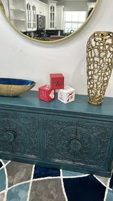a green dresser with two boxes and a mirror at R&R Hostal in Miami