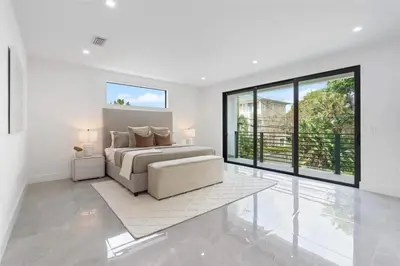 a white bedroom with a bed and a large window at Beautiful Property in Fort Laurderdale in Fort Lauderdale