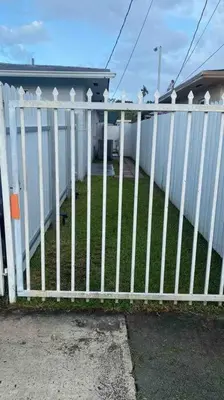 a white picket fence in front of a house at Private and Comfortable Suite near Airport Miami in Miami