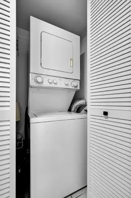 a white refrigerator with a microwave on top of it at Stylish 1BR Brickell Condo with Balcony and Pool Access in Miami
