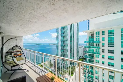 a balcony with a view of the ocean and buildings at Stylish 1BR Brickell Condo with Balcony and Pool Access in Miami