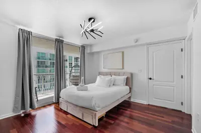 a white bedroom with a bed and a window at Stylish 1BR Brickell Condo with Balcony and Pool Access in Miami