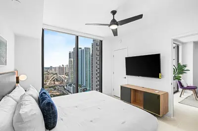 a bedroom with a bed and a flat screen tv at NEW Luxurious Apartment Floor 35th - Miami's heart in Miami
