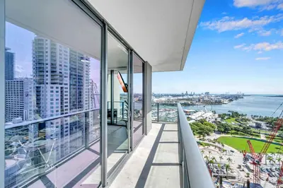 an apartment balcony with a view of the ocean at Mesmerizing Water Views Corner Condo in Miami