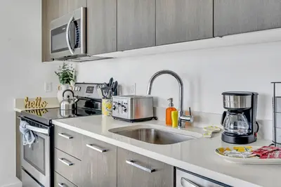 a kitchen with a sink and a microwave at Mesmerizing Water Views Corner Condo in Miami