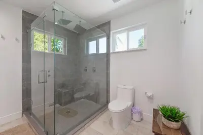a bathroom with a shower and a toilet at Charming House with Private Pool n Coral Gable in Miami