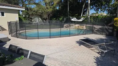 a swimming pool with a fence around it at Charming House with Private Pool n Coral Gable in Miami