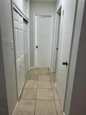 a hallway with a white door and a tile floor at Apartment in Hollywood close to beach & shops 101 in Hollywood