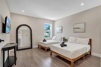 a bedroom with two beds and a mirror at Spacious Luxury Villa in Hollywood 6BR 5-Bath 5-Min Walk to Beach & Attractions in Hollywood