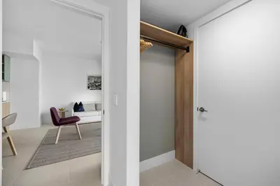 a door leading into a living room with a red chair at Lux Downtown Miami w Free Parking in Miami