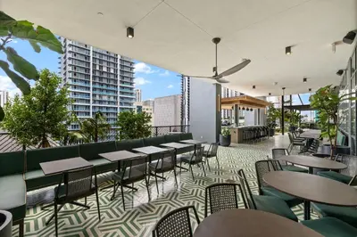 a restaurant with tables and chairs on a balcony at Lux Downtown Miami w Free Parking in Miami