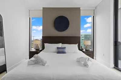 a bedroom with a large white bed with two pillows at Free Parking! PH Luxury 3BR in Downtown Miami in Miami