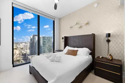 a bedroom with a large bed with a large window at Free Parking! PH Luxury 3BR in Downtown Miami in Miami