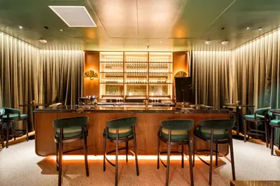 a bar in a restaurant with green chairs at Free Parking! PH Luxury 3BR in Downtown Miami in Miami
